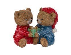 Due orsetti di Natale seduti in resina con pigiama scozzese rosso e blu che si scambiano un pacco regalo verde