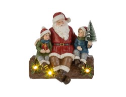 Statua di Babbo Natale seduto su un tronco con bambini e luci LED in resina alta 17 cm