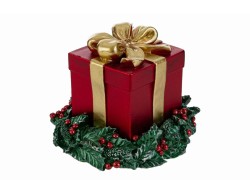 Candela natalizia in cera rossa a forma di pacchetto regalo con fiocco oro e base a ghirlanda verde